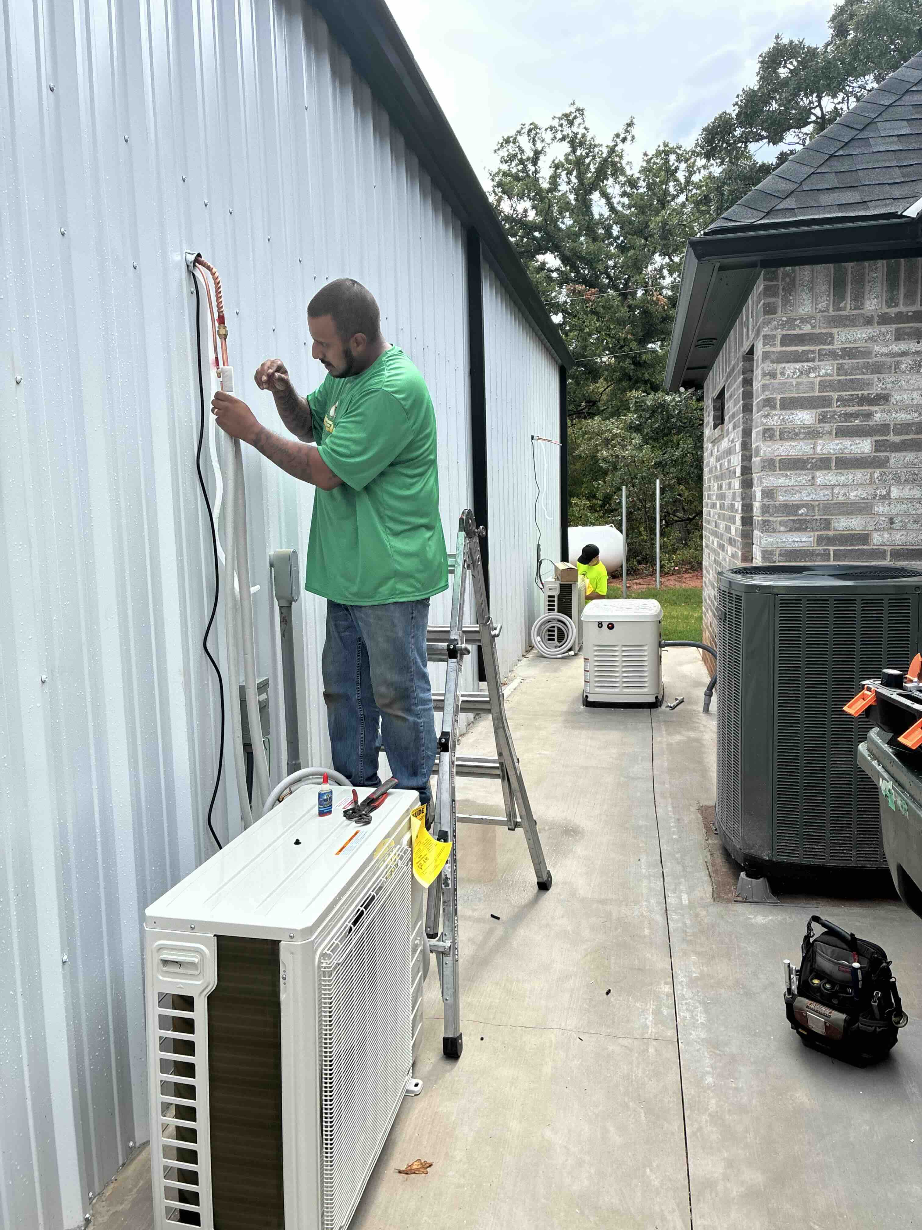 Direct Air technician servicing an outdoor AC unit